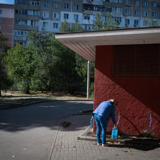 Kvinne som fyller vann på dunk